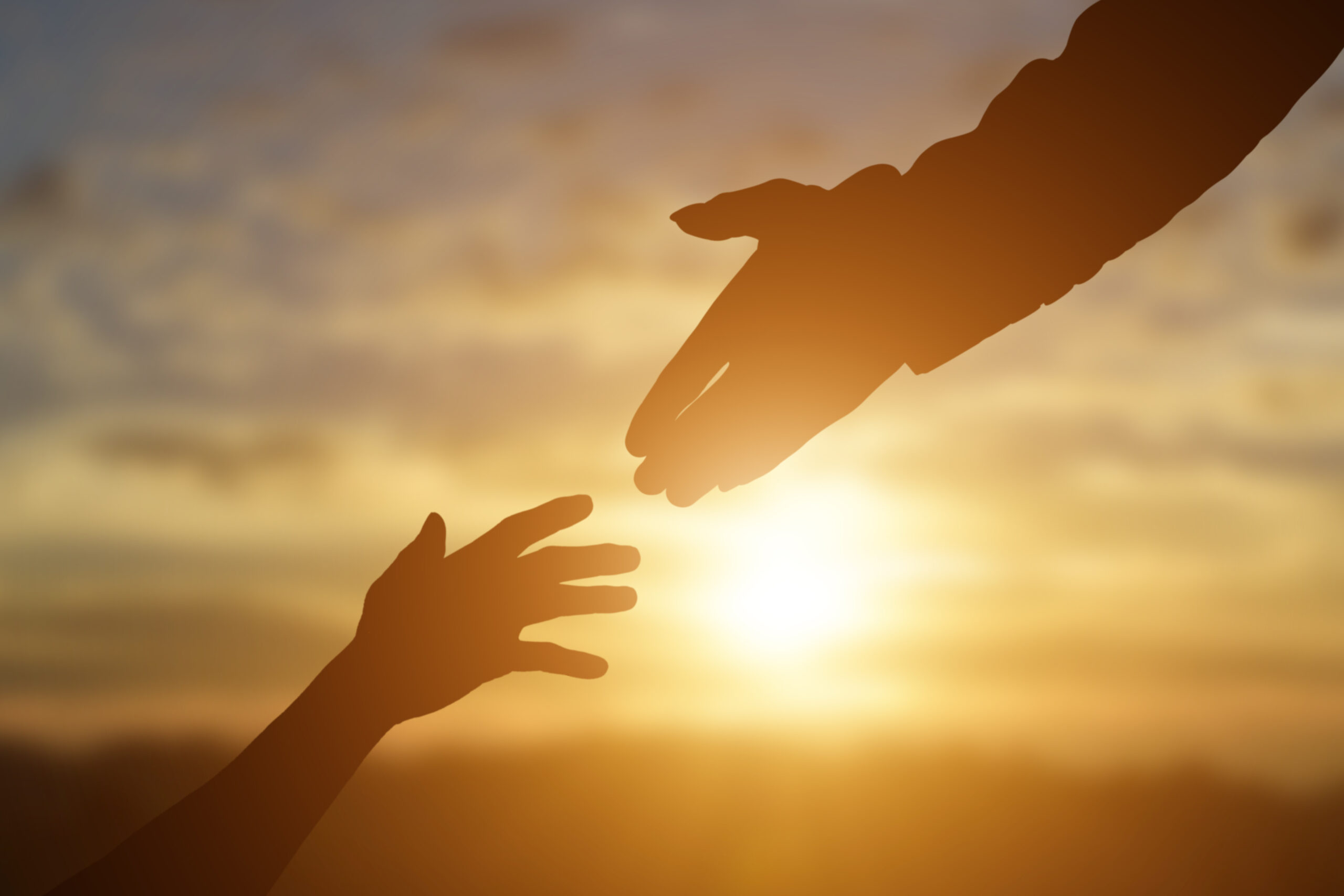 Two hands reaching towards eachother